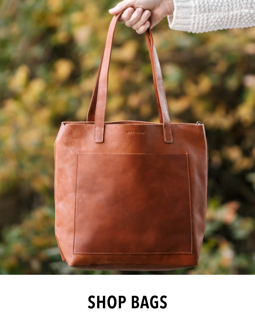 Woman holding a MADE FREE ethically made sustainable brown leather tote bag
