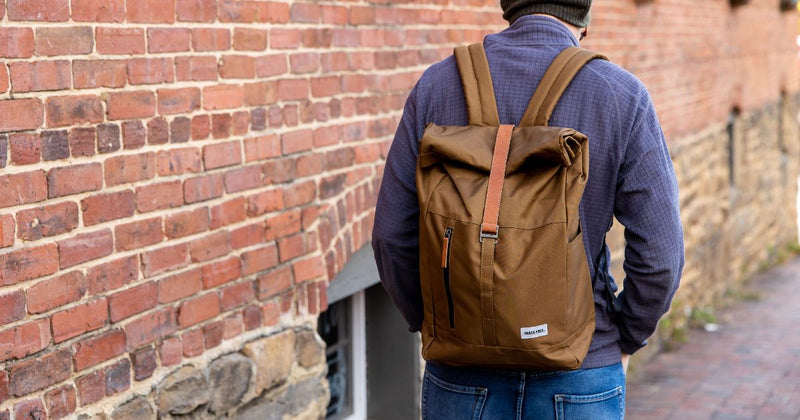 person wearing recycled poly backpack at school