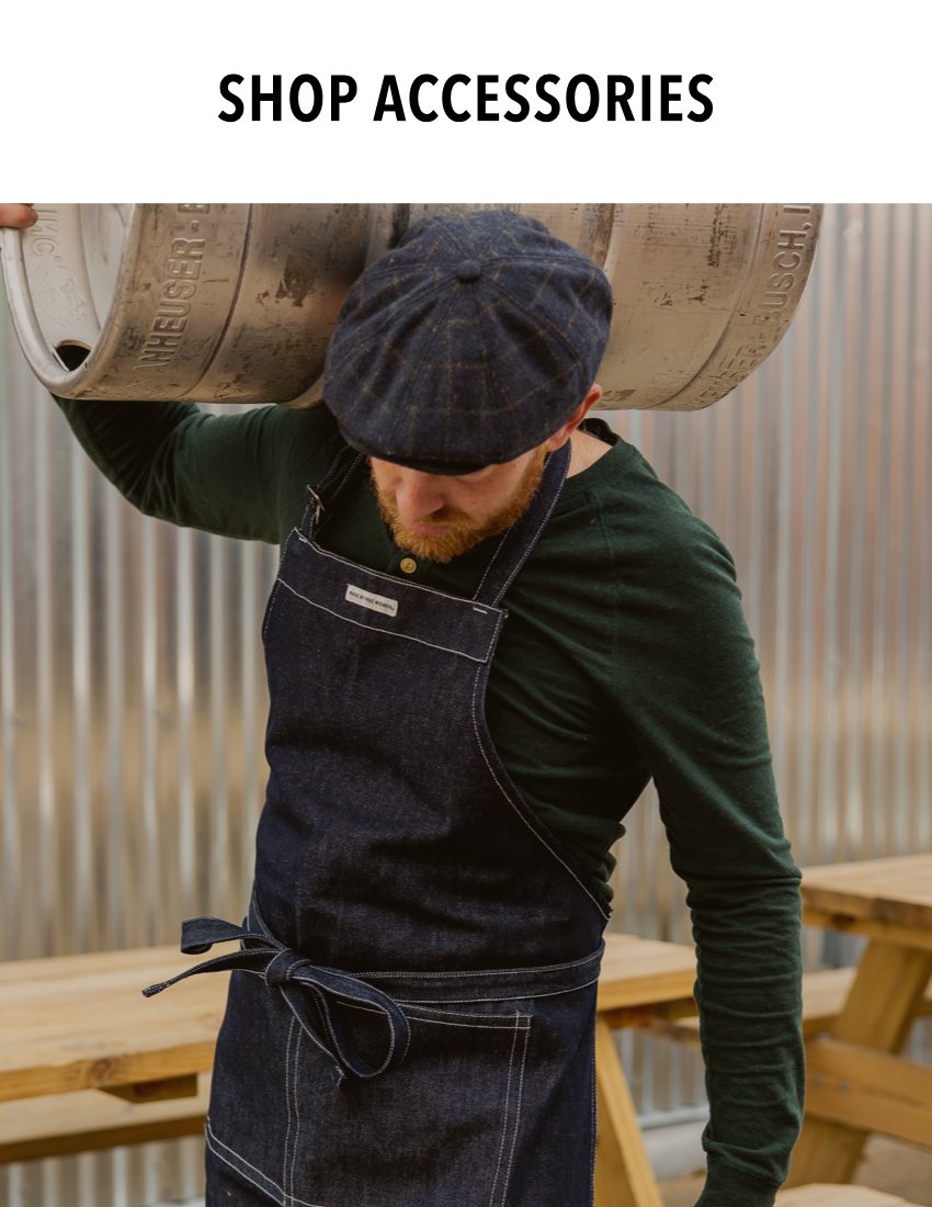 Male brewer wearing MADE FREE Navy Apron, ethically made by free women