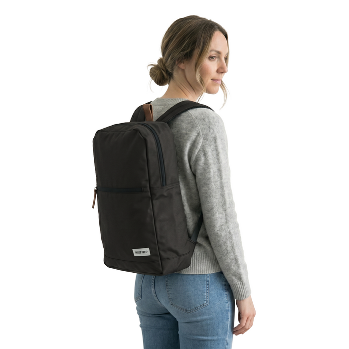 MADE FREE Urban Pack Mini AW in charcoal worn by model in studio setting
