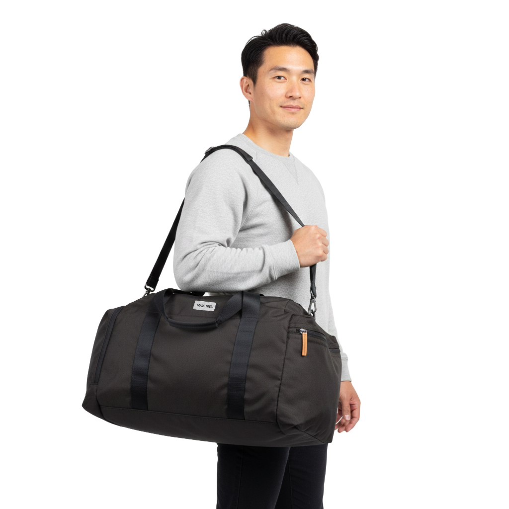 MADE FREE Weekend Duffle AW in charcoal worn by model in studio setting