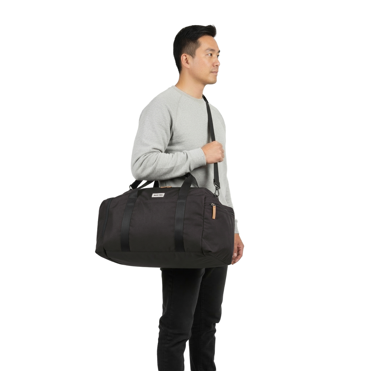 MADE FREE Weekend Duffle AW in charcoal worn by model in studio setting